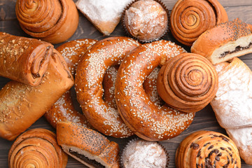 Heap of tasty pastries on wooden background