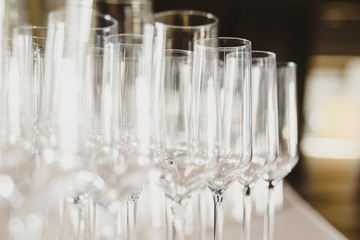 Poster - Group of empty and transparent champagne glasses in a restaurant.Group of empty and transparent champagne glasses in a restaurant.