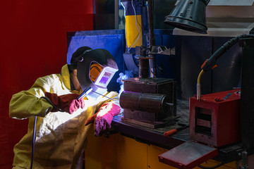 Poster - Electric welding. Welder brews metal. Electric welder works. The welding process at the factory. Welding metals. Metal processing. Metalworking. Metallurgy.