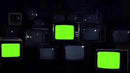 Wall Mural - three retro televisions turning on green screen. blue dark tone. zoom in.