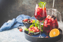 Red Wine Sangria Or Punch With Fruits And Ice In Glasses And Pincher. Homemade Refreshing Fruit Sangria.