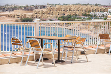 Wall Mural - Table and chairs in beach cafe next to the red sea in Sharm el Sheikh, Egypt