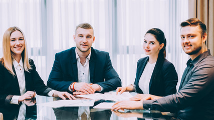 Wall Mural - Corporate lifestyle. Confident, successful professional team sitting in modern conference room.