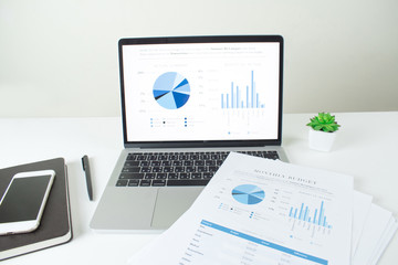 Poster - Financial business desk. Modern office Focus on the laptop screen with charts and diagrams.