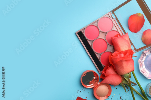 Fotografía Flat lay composition with coral cosmetics and flowers on light blue background