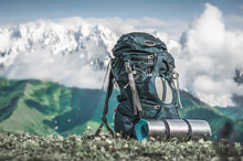 Tourist Backpack And Sleeping Pad On A Background Of Mountains