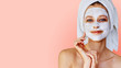 Leinwandbild Motiv Beautiful young woman with facial mask on her face. Skin care and treatment, spa, natural beauty and cosmetology concept.