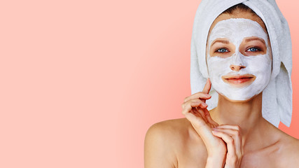Wall Mural - beautiful young woman with facial mask on her face. skin care and treatment, spa, natural beauty and
