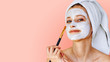 © Olesia - Beautiful woman applying facial mask on her face with brush. Skin care and treatment, spa, natural beauty and cosmetology concept.