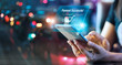 © ipopba - Woman using mobile smart phone in the night light colorful background