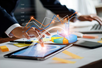 Leinwandbilder - Businessman using tablet and laptop analyzing sales data and economic growth graph chart. Business strategy. Digital marketing. Business innovation technology concept