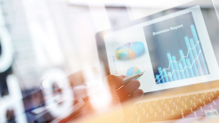 Poster - Businessman analyzing sales data and pointing at business graph chart growth and progress on laptop screen. Digital marketing and business strategy.