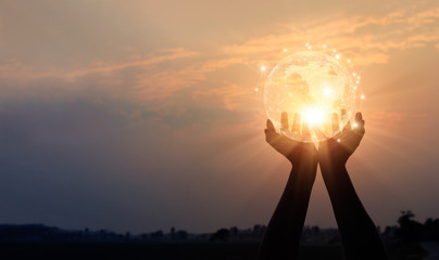 Leinwandbilder - Abstract networking. Technology and communication. Hands holding global network and data exchanges on sunset background..