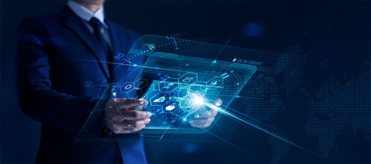 Leinwandbilder - Businessman holding modern virtual interface banking in hand with icon network connection, shopping and mobile payment online on dark background