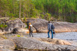 © Tatyana_Andreyeva - Middle aged man and young lady walking on northern lake shore in summer day. Tourists against picturesque landscape. Travelling and discovering distant places of Earth. Onega lake, Karelia, Russia