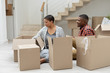 © wavebreak3 - Couple unpacking cardboard boxes in living room