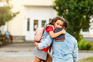 Father picking daughter up from school