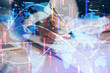 © peshkova - International business hologram over hands taking notes background. Concept of success. Multi exposure