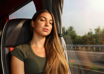 Canvas Print - Young beautiful woman sleeping sitting in the bus. Bus passenger traveling sitting in a seat and sleeping.