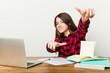 © Asier - Young teenager going back to her routine doing homeworks cheerful smiles pointing to front.