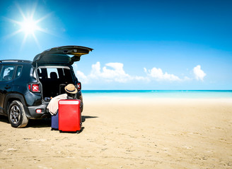 Black summer car on beautiful sunny beach. Summer journey and stopover on the beach.