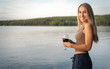 © Vicky - Pretty young woman in summer time with her red glass of wine in front of a calm lake at sunset