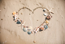 View Of Drawn Love Heart Symbol On Sand Beach