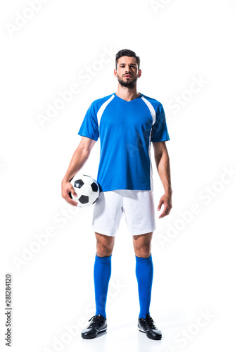 Fotomural handsome soccer player in uniform with ball Isolated On White
