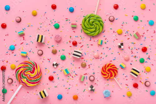 flat lay of festive background with assortment of colourful caramel candies w...