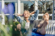 © Westend61 - Smiling woman with laptop relaxing on garden bench