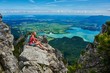 © Westend61 - Germany, Bavaria, Young woman taking a break after running in the mountains