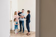 © Westend61 - Real estate agent and family in new apartment