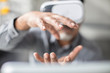 © Westend61 - Man shaping with his hands wearing VR glasses in office