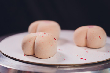 Confectioner decorates the cake with velour using the spray gun.