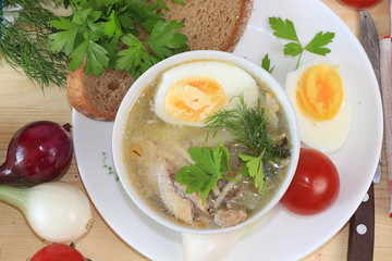 Traditional Russian soup with egg and bread on a wooden table. Delicious traditional natural food and cooking ingredients, healthy diet concept, top view,