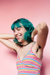 © Lucas Ottone/Stocksy - Portrait of laughing teen with green hair