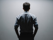 © JIACHUAN LIU/Stocksy - business man's back under light