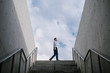 © JIACHUAN LIU/Stocksy - Business Man Walking On Top Of The Stairs