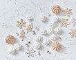 © Yaroslav Danylchenko/Stocksy - Beautiful pattern of origami paper balls, dry twigs, wooden stars and Christmas trees on a gray background. Christmas layout. Flat lay