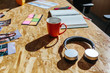 © MyMicrostock/Stocksy - Modern headphones and coffee on a wooden office table