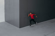 © Lumina/Stocksy - A Man Running by the Grey Wall