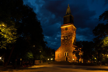 Wall Mural - Night view of the square and the tower of the Cathedral of the 13th century with illumination against the background of a summer, dark, night sky. Turku city, historical landmark of Finland.