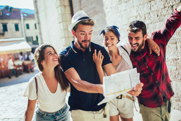 Happy group of tourists traveling and sightseeing together