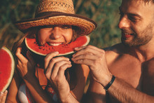 Young Attractive Woman And Man Eats Watermelon During The Summer Sunny Day
