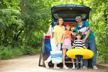 Wall Mural - Happy family near car prepared for travelling