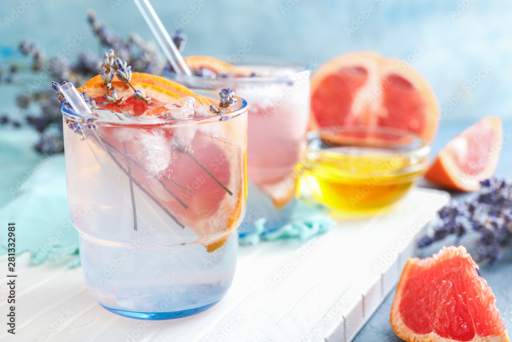 Glass with lavender lemonade on white board, closeup