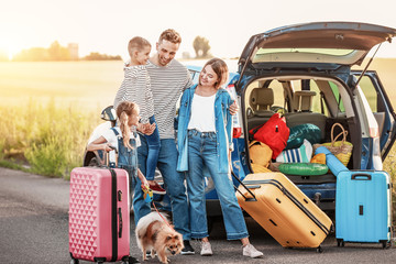 Happy family with luggage near car outdoors