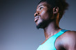 © LIGHTFIELD STUDIOS - handsome, confident african american sportsman looking away on grey background with lighting