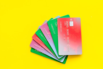 Bank card, debit, credit on yellow background top view