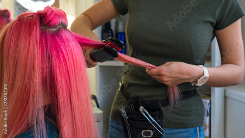 Hairdresser Makes Hairstyle To Client Using Crimping Irons